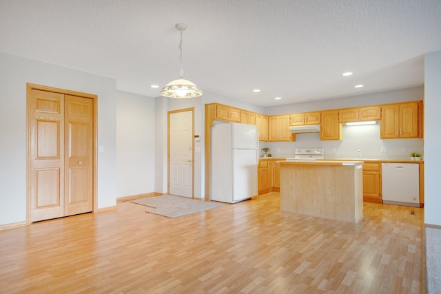 16377 Eidelweiss St NW, Andover, MN 55304 - kitchen with white appliances, a center island, light countertops, under cabinet range hood, and light wood-style floors
