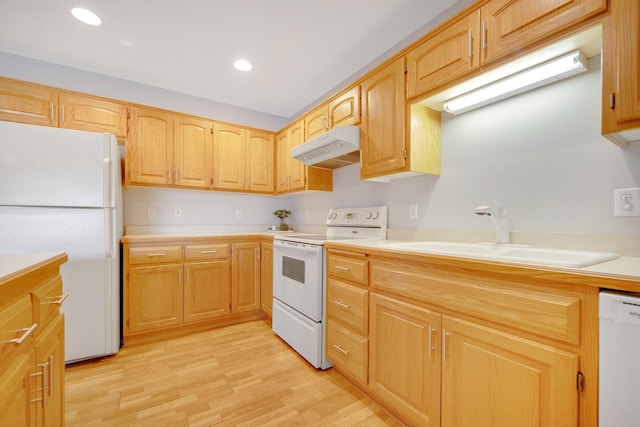 16377 Eidelweiss St NW, Andover, MN 55304 - kitchen with a sink, light countertops, white appliances, under cabinet range hood, and light wood finished floors