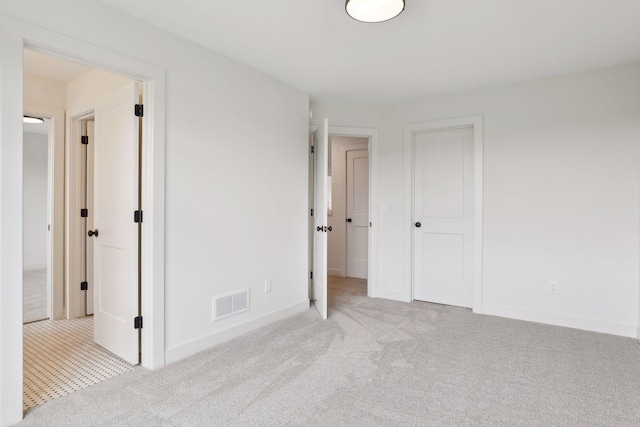 unfurnished bedroom featuring light colored carpet