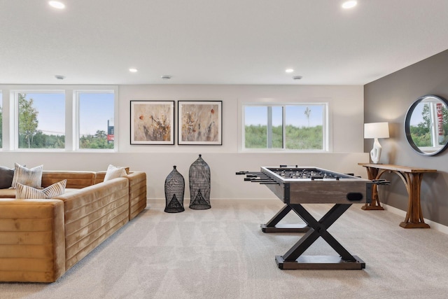 recreation room featuring light colored carpet and a wealth of natural light