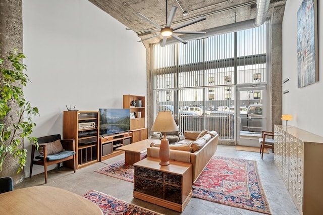 interior space featuring a high ceiling, plenty of natural light, and ceiling fan