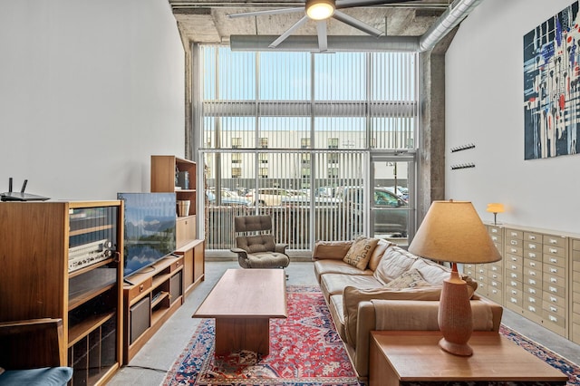 living room featuring ceiling fan and floor to ceiling windows