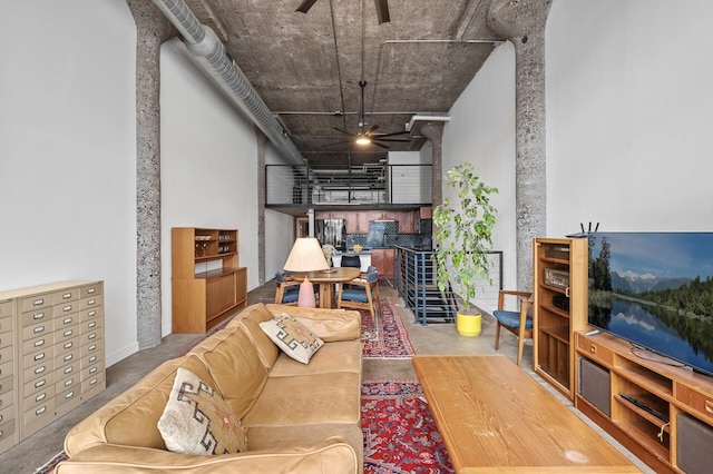 living room with concrete flooring and ceiling fan