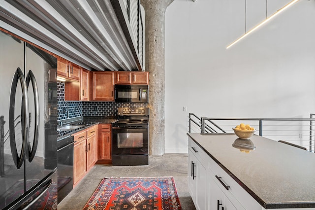 kitchen featuring tasteful backsplash, white cabinets, sink, and black appliances