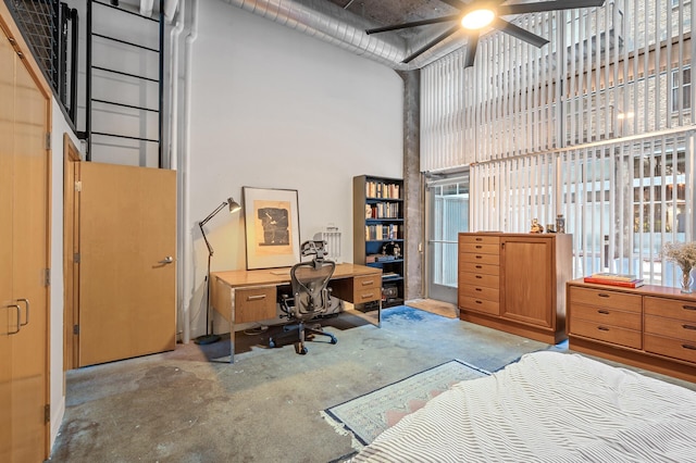 bedroom featuring ceiling fan and a high ceiling