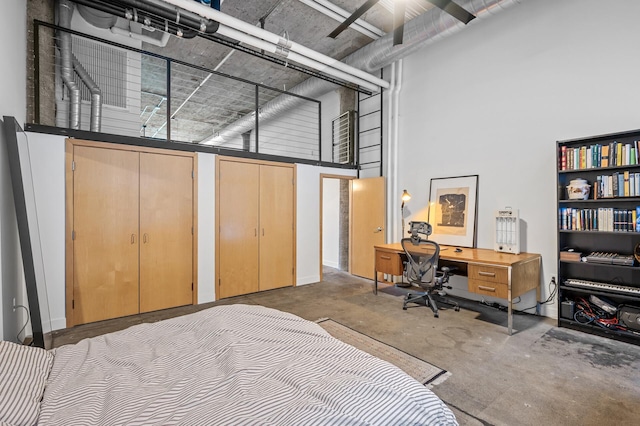 bedroom featuring a towering ceiling and two closets