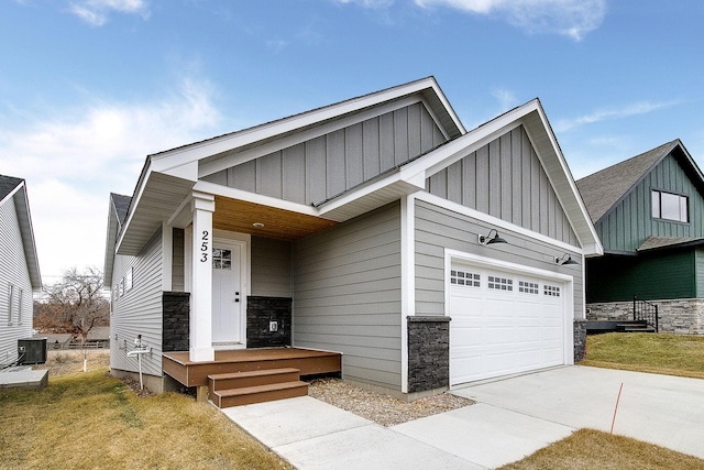 craftsman inspired home featuring a garage and central AC unit