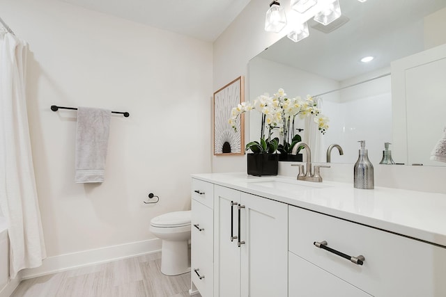 bathroom featuring vanity and toilet