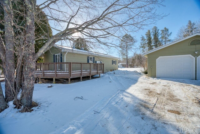 view of front of home with a wooden deck and a garage