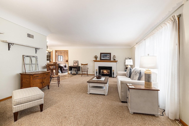 living room with a chandelier and carpet floors