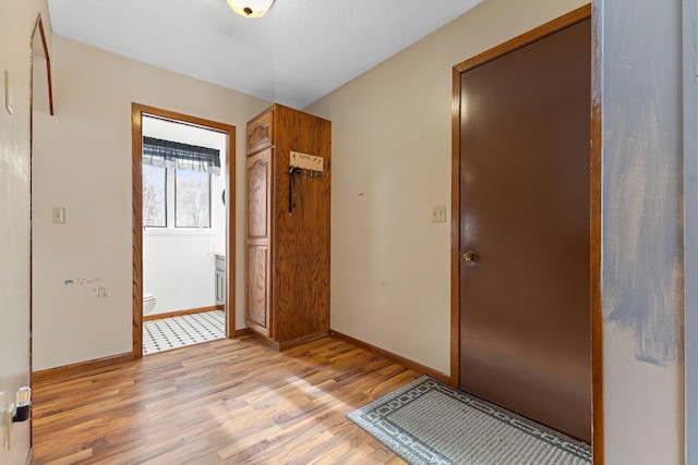 entryway featuring a textured ceiling and light hardwood / wood-style floors