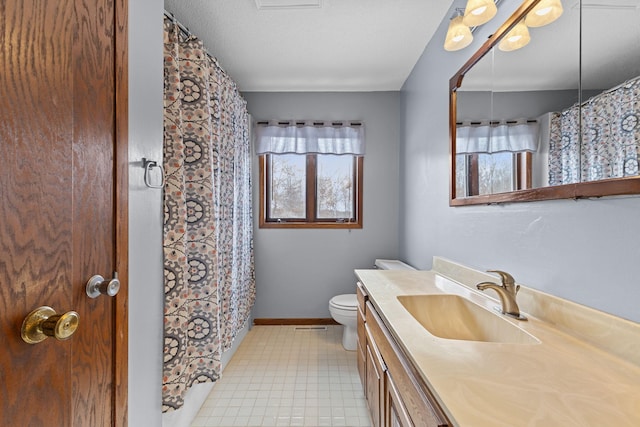 bathroom with vanity, tile patterned floors, a textured ceiling, and toilet