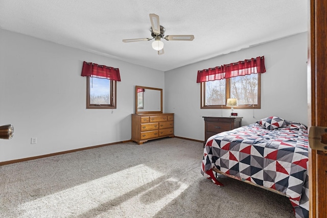 bedroom featuring ceiling fan, a textured ceiling, and carpet