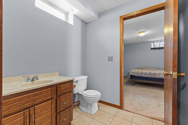 bathroom featuring vanity, toilet, and tile patterned flooring