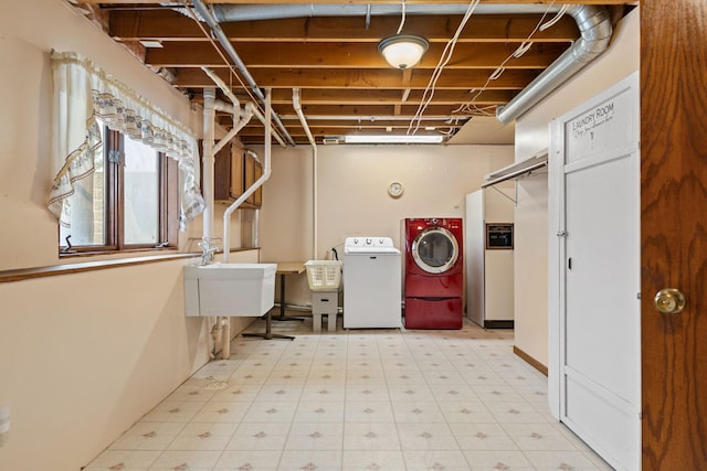 washroom with washing machine and clothes dryer and sink