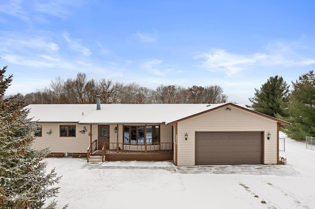 ranch-style home featuring a garage and covered porch