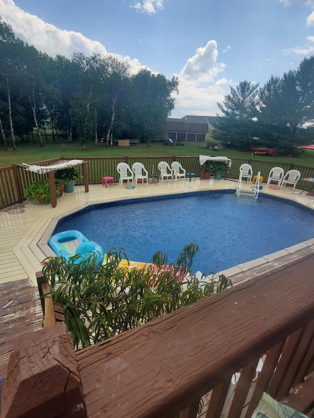 view of swimming pool featuring a wooden deck