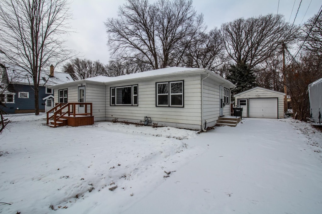 view of front of property with a garage and an outdoor structure