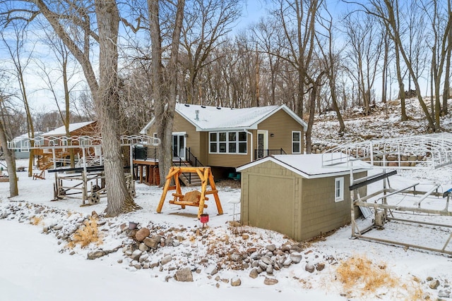 snow covered property with a storage unit