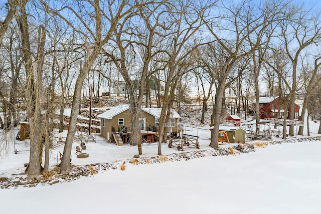 yard covered in snow featuring a deck