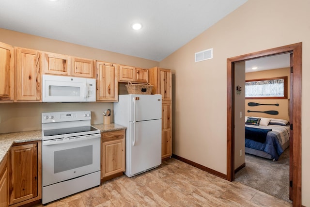 kitchen featuring light stone countertops, light brown cabinetry, lofted ceiling, and white appliances