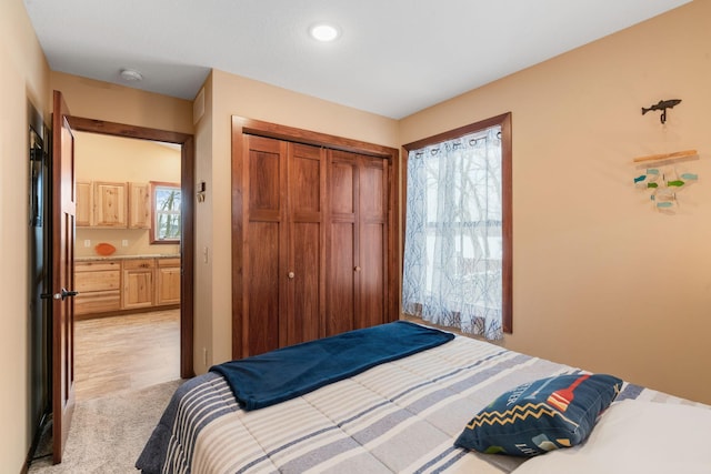 bedroom with a closet and light colored carpet