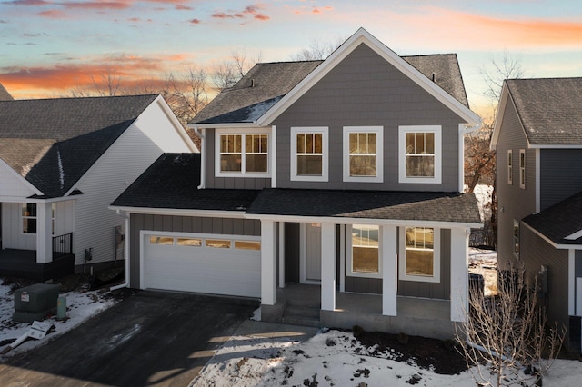 view of front of house featuring a porch and a garage