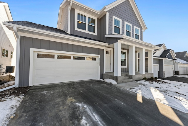 view of front of home with a garage and a porch