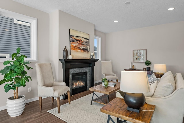 living room with hardwood / wood-style floors and a textured ceiling