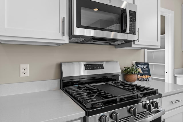 kitchen with stainless steel appliances and white cabinets