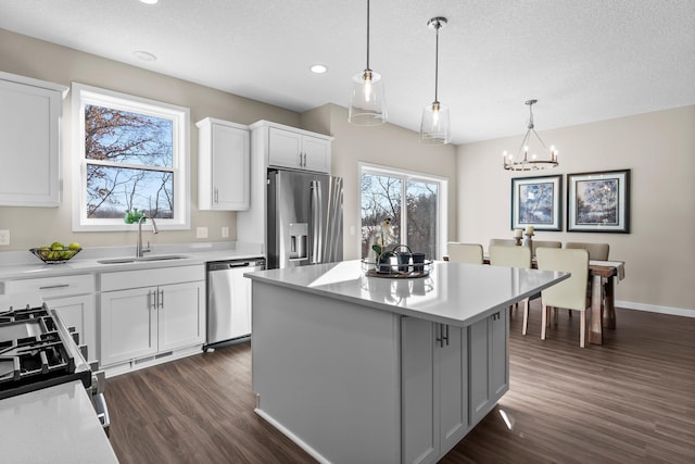 kitchen featuring white cabinetry, stainless steel appliances, and a kitchen island