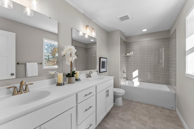 full bathroom with vanity, toilet, and tiled shower / bath