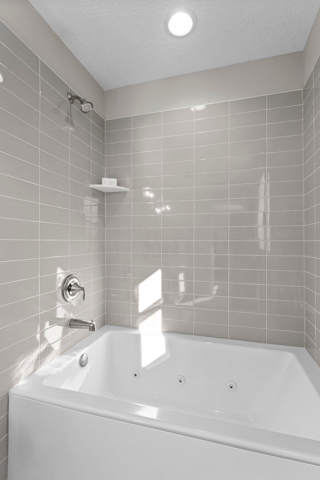 bathroom featuring a textured ceiling and shower / bathing tub combination