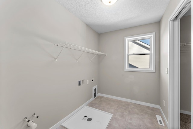 washroom with hookup for a gas dryer, washer hookup, hookup for an electric dryer, and a textured ceiling