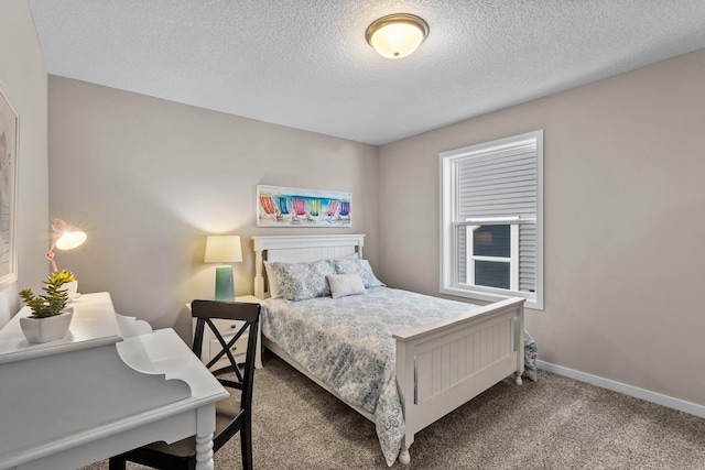 bedroom featuring a textured ceiling and carpet flooring