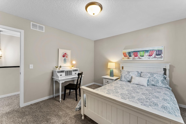 bedroom featuring a textured ceiling and carpet