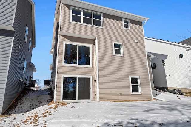 snow covered property featuring central air condition unit