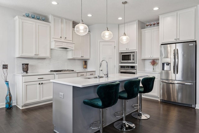 kitchen with white cabinetry, sink, premium range hood, and appliances with stainless steel finishes