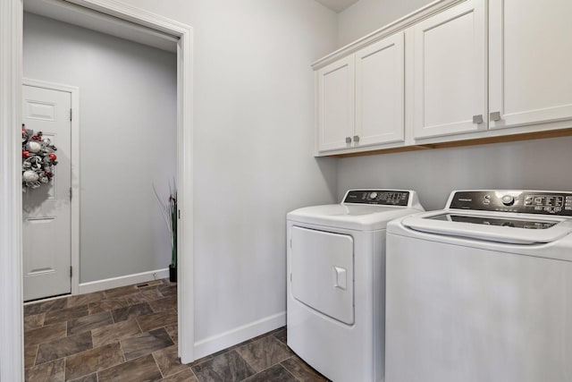 laundry room with cabinets and washing machine and clothes dryer