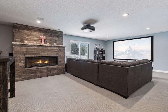 cinema with light carpet, a textured ceiling, and a fireplace