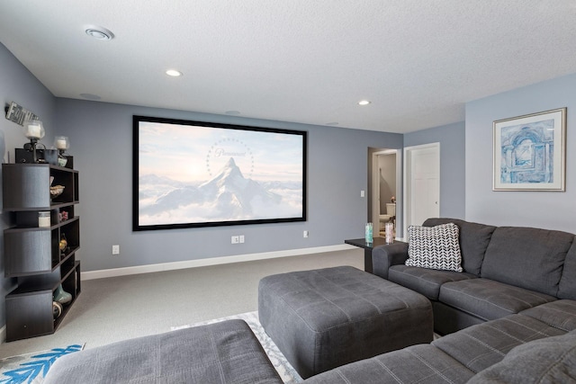 carpeted home theater room with a textured ceiling