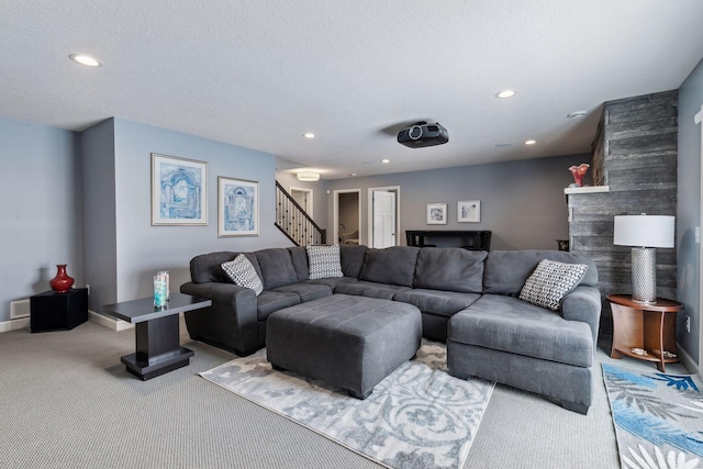 carpeted living room featuring a textured ceiling