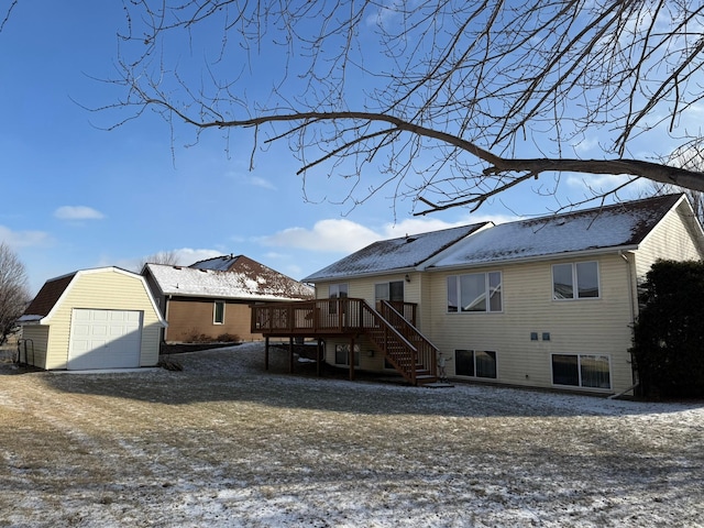 rear view of house with an outbuilding, a garage, and a wooden deck