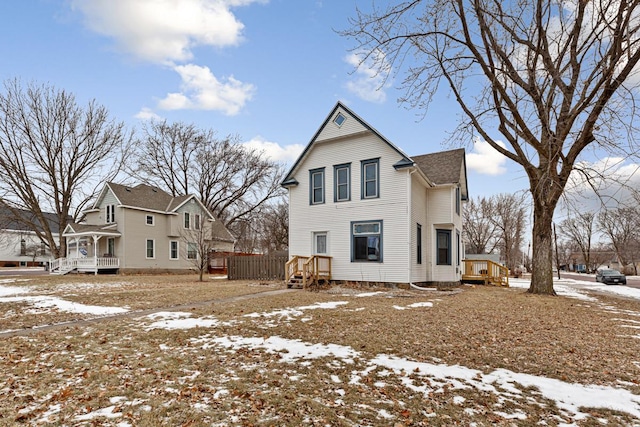 view of snow covered rear of property