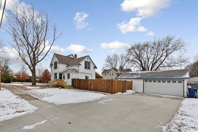 view of snowy exterior with a garage