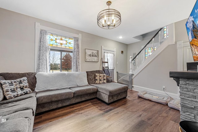 living room with an inviting chandelier and hardwood / wood-style flooring