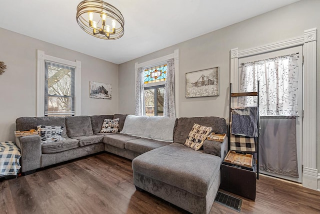 living room with hardwood / wood-style floors and a chandelier