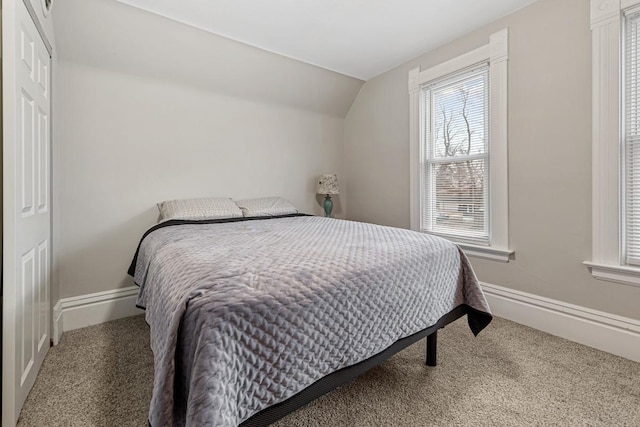 carpeted bedroom with vaulted ceiling