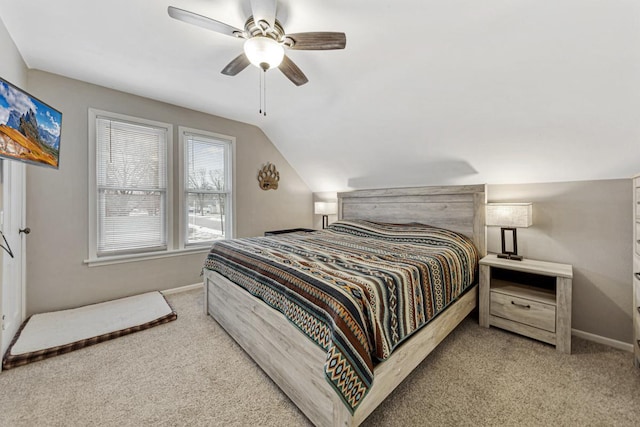 bedroom with ceiling fan, vaulted ceiling, and light carpet