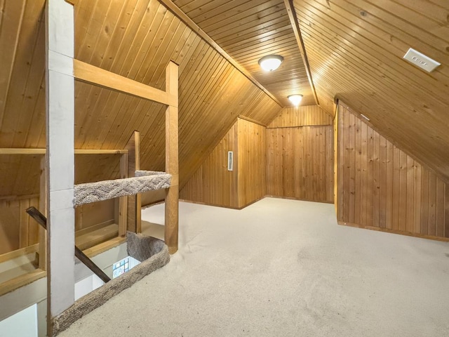 additional living space with carpet floors, vaulted ceiling, wood walls, and wooden ceiling